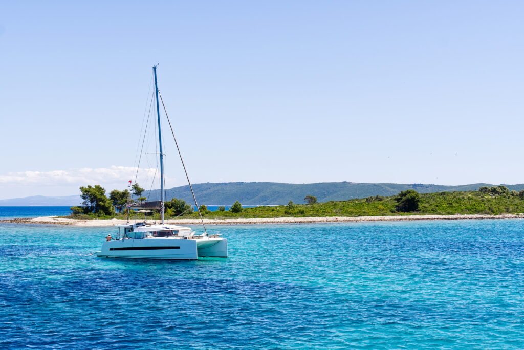 catamaran sailing in ocean. paradice at sea. Blue sky and turquoise blue sea water.